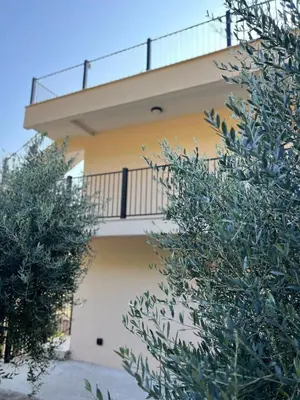a building with a balcony on the side of it at Apartments HAS in Kotor