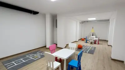 a room with a table and chairs and a play tent at Olive Tree Apartments in Becici