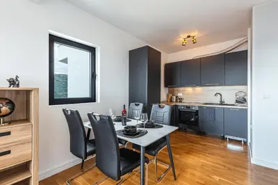 a kitchen and dining room with a table and chairs at Olive Tree Apartments in Becici