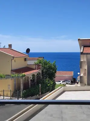 a view of the ocean from the balcony of a building at SD LUX APARTMENTS in Dobra Voda