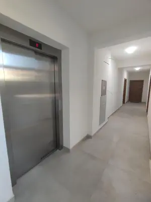 an empty hallway with a sliding door in a building at SD LUX APARTMENTS in Dobra Voda