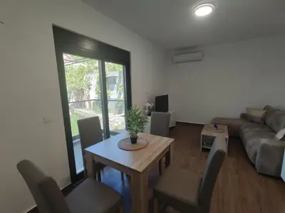 a living room with a table and a couch at SD LUX APARTMENTS in Dobra Voda