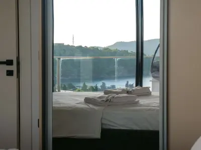 a bedroom with a bed with a view of a window at Elia Suites in Becici