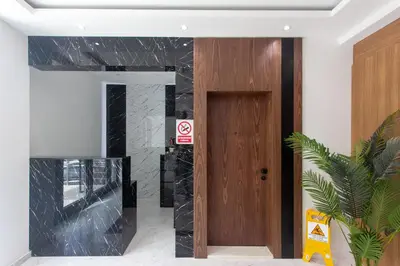 a lobby with a wooden door and a plant at Elia Suites in Becici