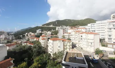 a view of a city with buildings and a mountain at Elia Suites in Becici
