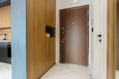 a hallway with a wooden door in a kitchen at Elia Suites in Becici
