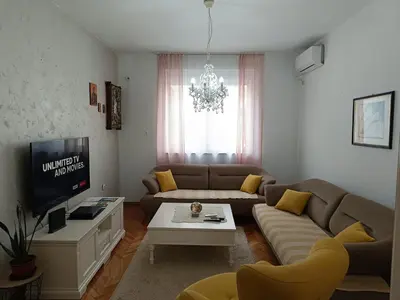 a living room with a couch and a tv at center_apartment_LUX in Podgorica