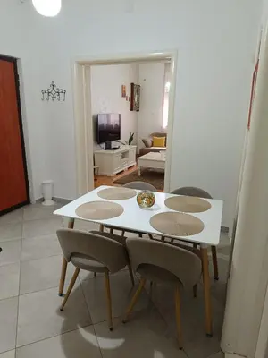 a white table and chairs in a living room at center_apartment_LUX in Podgorica