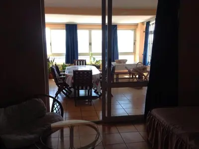a living room with a table and a dining room at Villa Barcelona in Sutomore