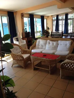 a living room with a white couch and chairs at Villa Barcelona in Sutomore