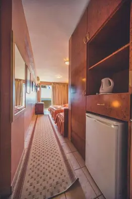 a hotel room with two beds and a bathroom at Villa Barcelona in Sutomore