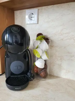 a black coffee maker sitting on a counter next to a box at Apartman Marija sa ličnim đakuzijem in Becici