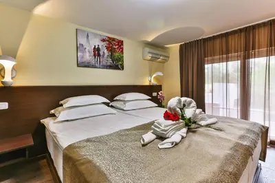 a bedroom with two beds with flowers on it at Hotel Premier in Budva