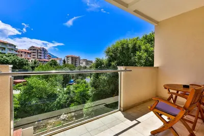 a balcony with a table and chairs and a view at Hotel Premier in Budva