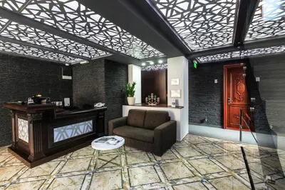 a living room with a chair and a table at Hotel Premier in Budva