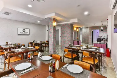 a dining room with wooden tables and chairs at Hotel Premier in Budva