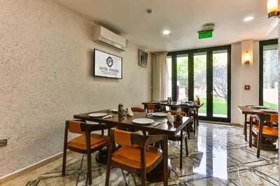 a dining room with wooden tables and chairs at Hotel Premier in Budva