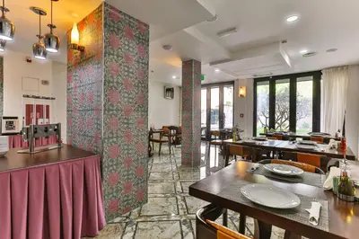 a dining room with tables and chairs and a restaurant at Hotel Premier in Budva