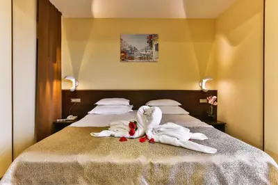 a bed with two swans made out of towels at Hotel Premier in Budva