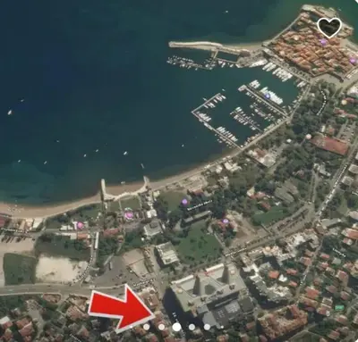 an aerial view of a beach with a red arrow at Apartment Butua. in Budva