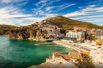 a view of a beach with buildings and the ocean at Apartment Butua. in Budva