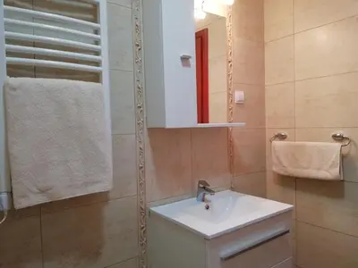 a bathroom with a sink and a mirror at Apartment Anatolia of Becici in Becici