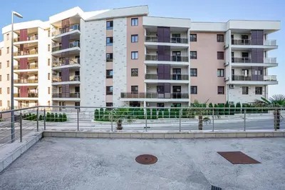 an empty parking lot in front of buildings at Apartment Anatolia of Becici in Becici
