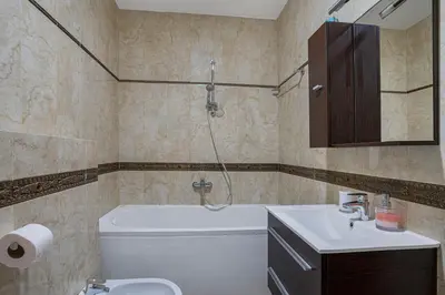 a bathroom with a tub and a toilet and a sink at Apartment Anatolia of Becici in Becici