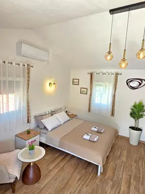a bedroom with a large bed and a couch at Sunny Side Apartments in Rijeka Crnojevića