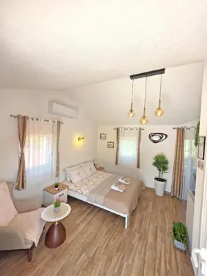 a bedroom with a bed and a couch at Sunny Side Apartments in Rijeka Crnojevića