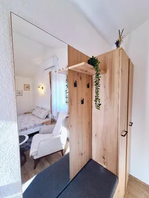 a room with a mirror and a room with a bed at Sunny Side Apartments in Rijeka Crnojevića