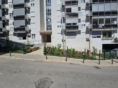 an empty street in front of a tall building at LaMar in Budva