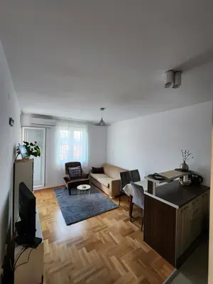 a living room with a couch and a tv at LaMar in Budva