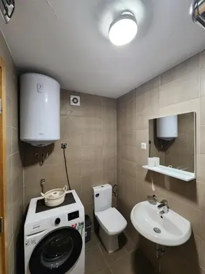 a bathroom with a washing machine and a sink at LaMar in Budva