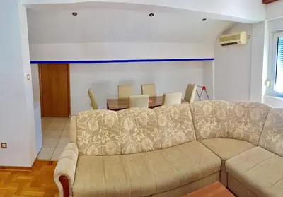 a living room with a couch and a table at Apartman Bravo Budva in Budva