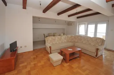a living room with a couch and a table at Apartman Bravo Budva in Budva