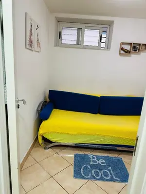 a yellow and blue bed in a room at Podgorica city center apartment in Podgorica