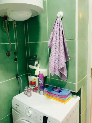 a bathroom with a washing machine and a towel at Podgorica city center apartment in Podgorica