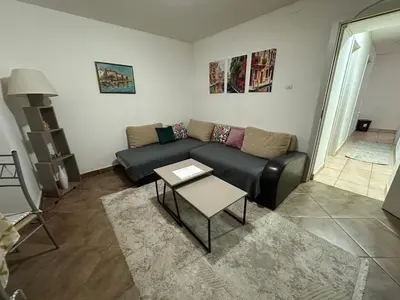 a living room with a couch and a table at Podgorica city center apartment in Podgorica