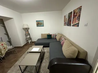a living room with a couch and a table at Podgorica city center apartment in Podgorica