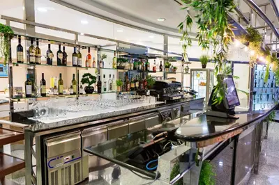 a bar with a lot of bottles of wine at Kings Park Hotel in Podgorica