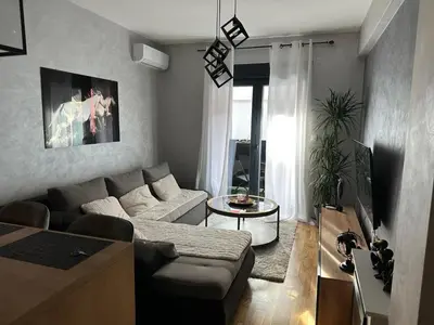a living room with a couch and a table at Arbo LUX Apartment in Podgorica