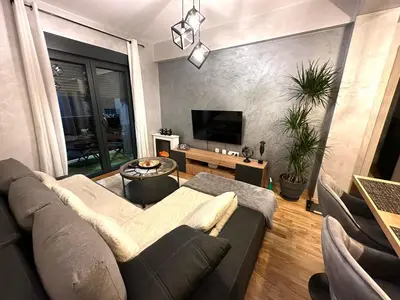 a living room with a couch and a tv at Arbo LUX Apartment in Podgorica