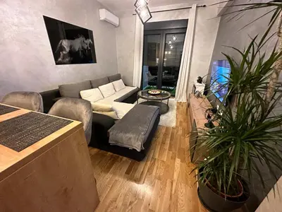 a living room with a couch and a table at Arbo LUX Apartment in Podgorica