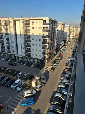 an aerial view of a parking lot with parked cars at Hanna apatment in Podgorica
