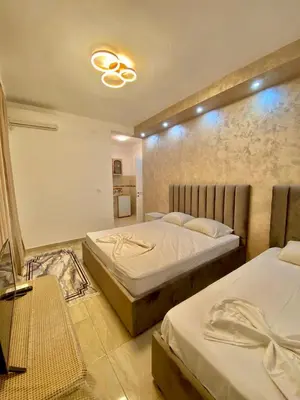 a bedroom with two beds and a ceiling at Long Beach Stay in Ulcinj