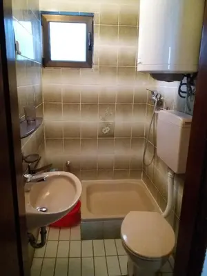 a bathroom with a sink and a toilet and a tub at Apartman - Sutomore in Sutomore