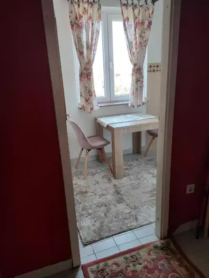 a dining room with a table and a window at Lepa Kata Centar in Podgorica