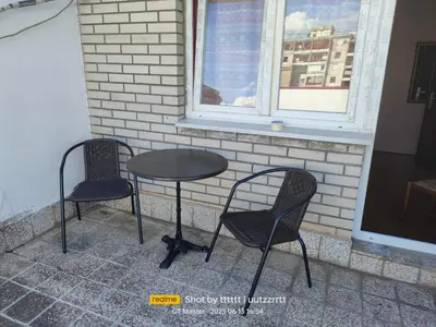 two chairs and a table in front of a window at Lepa Kata Centar in Podgorica