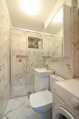a bathroom with a toilet and a shower and a sink at Apartman Oskar in Podgorica